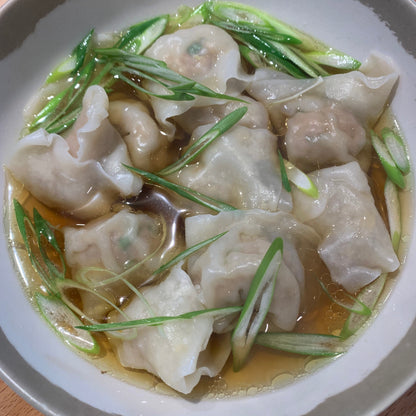 a bowl of dumplings with soup