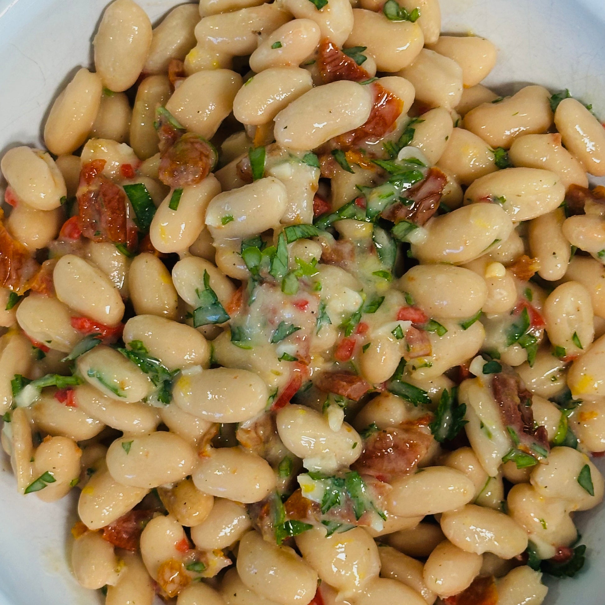 bowl of white bean salad with sundried tomatoes